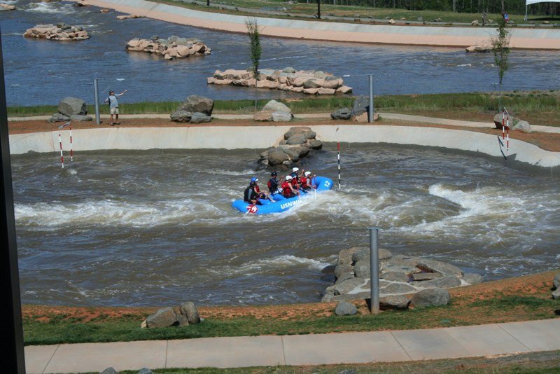 rafters riding the whitewater channel at the U.S. National Whitewater Center in spring
