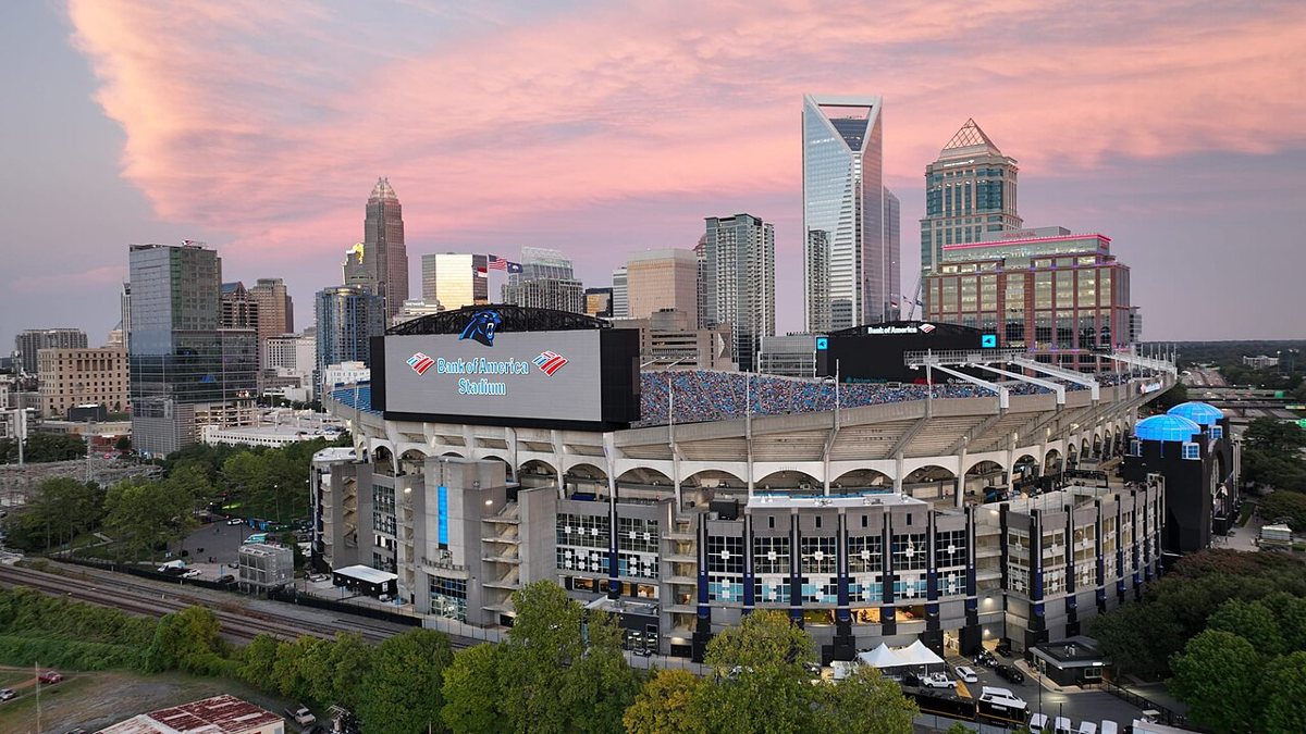 Bank of America Stadium and the uptown Charlotte skyline at dusk